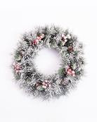 Snow-flocked Christmas wreath with artificial berries and pinecones