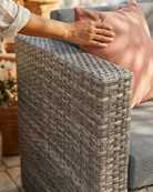Weather resistant rattan garden sofa with thick cushioned seating