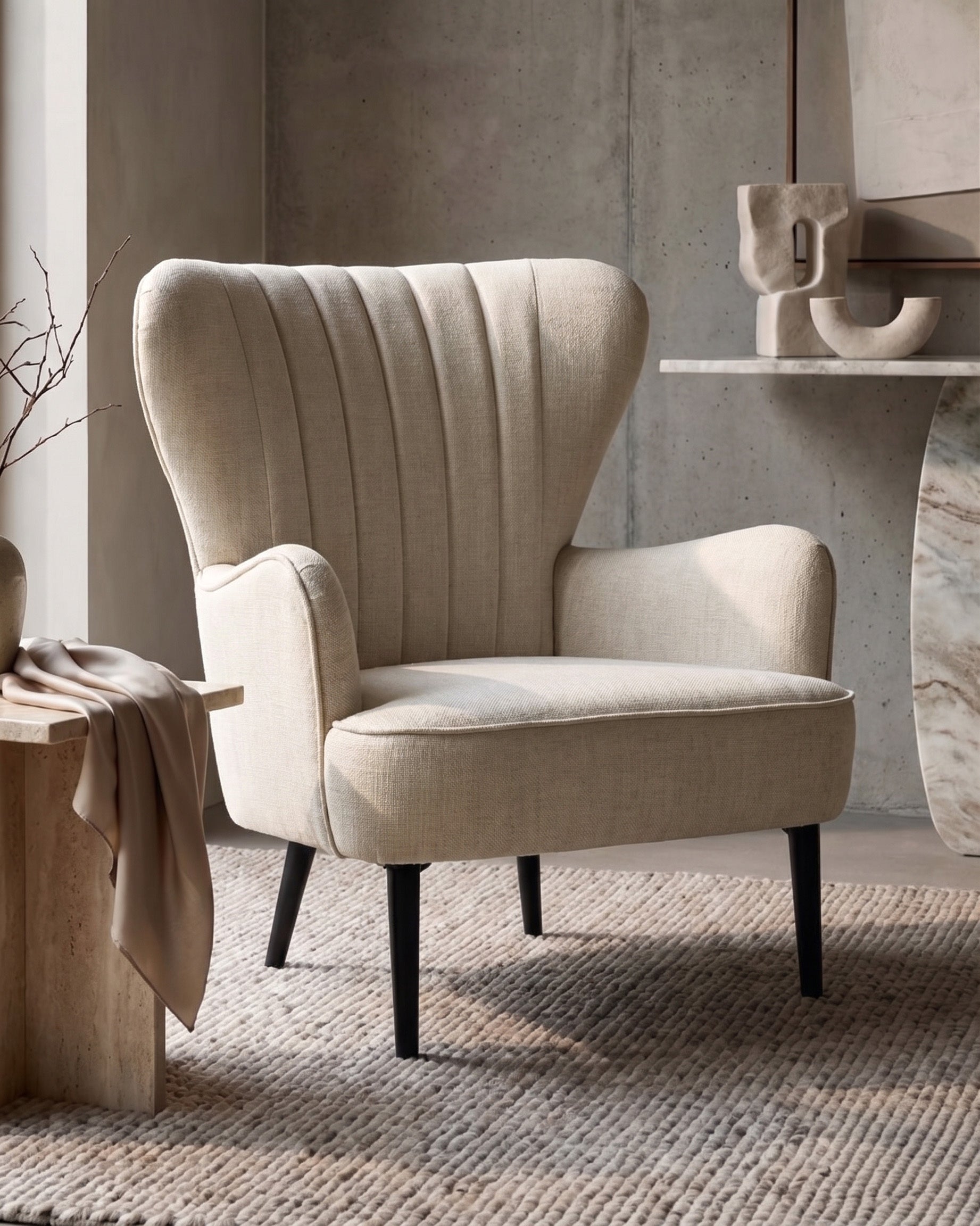 Fabric cream wingback chair in a modern interior setting with a wooden table