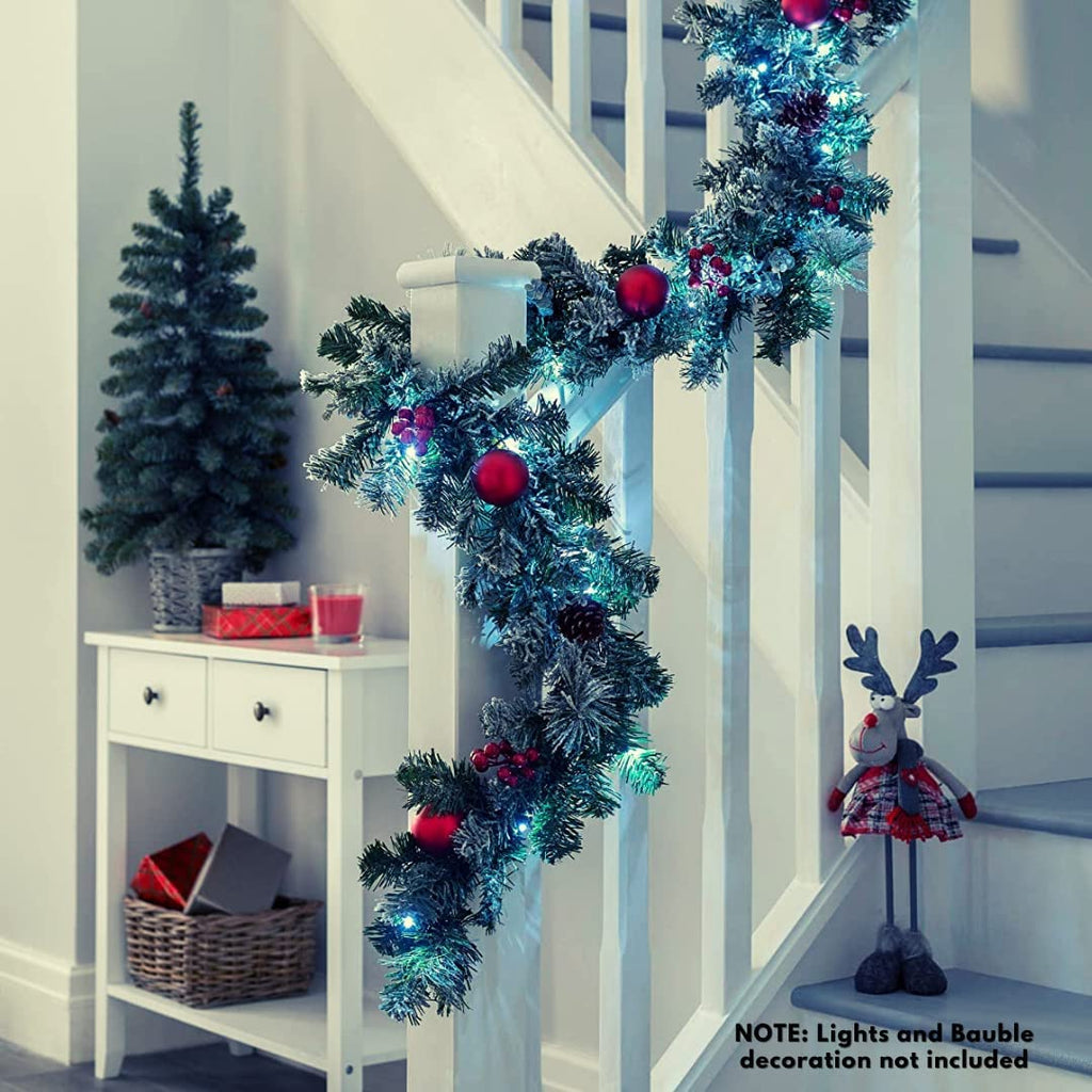 EVRE 9Ft Christmas Garland hanging on stair case rails decorated